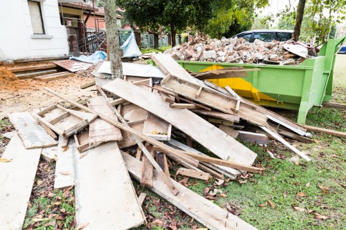 Builders skip being loaded with construction waste in Hampstead